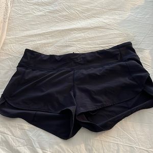 Navy blue short Lululemon running shorts with back zipper and drawstring.